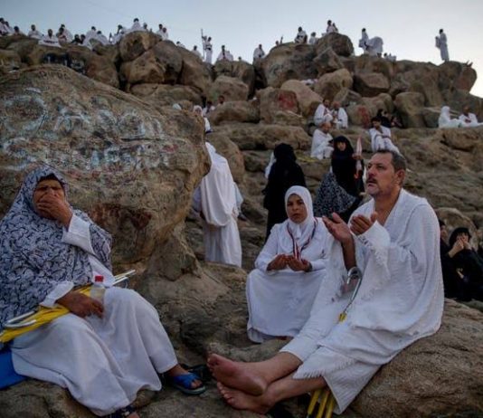 Masked Haj pilgrims on Mount Arafat pray for COVID-free world