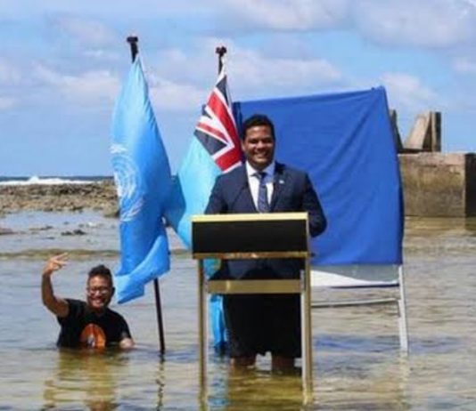 Tuvalu minister stands in sea to film COP26 speech to show climate change